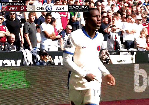 Soccer Player On Field With Premier League Scoreboard GIF