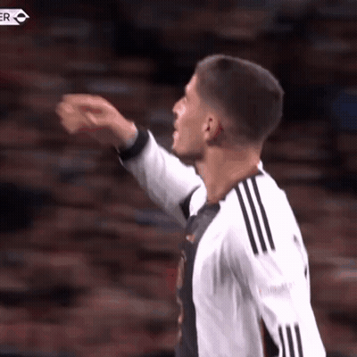 Soccer Player Pointing in Black and White Jersey