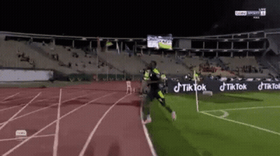 Soccer Player Running On Stadium Track GIF