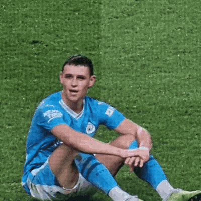 Soccer Player Sitting Cross-Legged On Grass GIF
