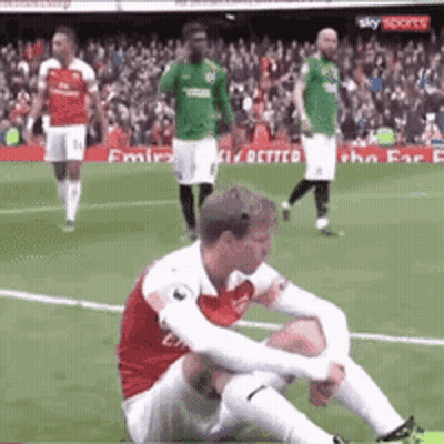 Soccer Player Sitting On Field During Game GIF