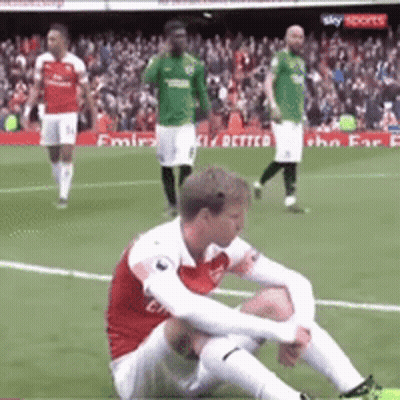 Soccer Player Sitting On Ground During Match GIF