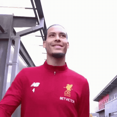 Soccer Player Smiling At Camera In Red Jacket GIF