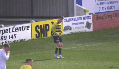 Soccer Player Standing In Front Of Sign Saying SNP GIF