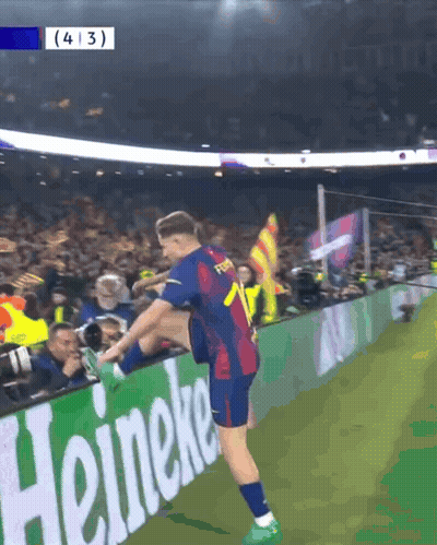Soccer Player Stretching Leg In Front Of Heineken Ad GIF