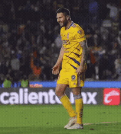 Soccer Player Walking Past Caliente Advertisement GIF