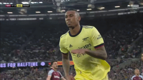 Soccer Player Wearing A Yellow Jersey That Says Emirates Fly Better On It GIF