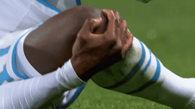 Soccer Player With Blue White Socks Holding Knee GIF