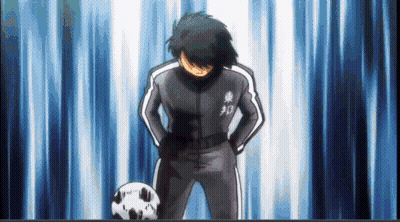 Soccer Player With Hands On Hips Beside Soccer Ball GIF