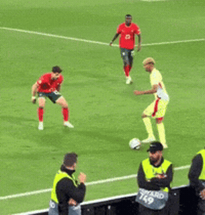 Soccer Players And Man In Number 49 Vest GIF
