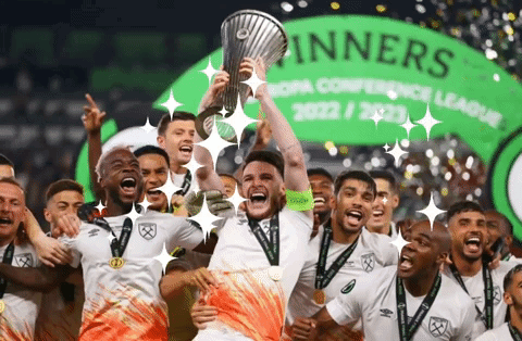 Soccer Players Celebrate With Trophy In Front Of Winners Banner GIF
