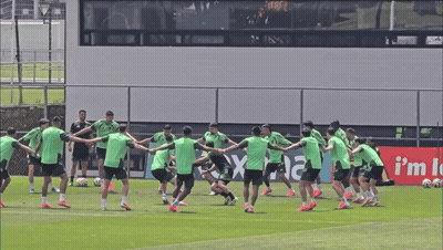 Soccer Players Holding Hands In Front Of Rex Sign GIF