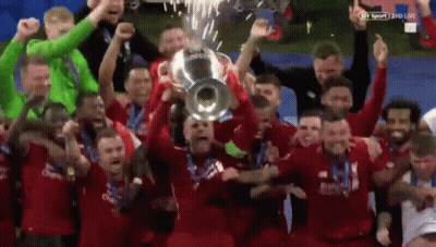Soccer Players Holding Trophy GIF