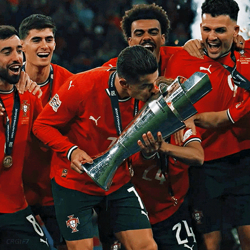Soccer Players Holding Trophy Number 24 On Shorts GIF