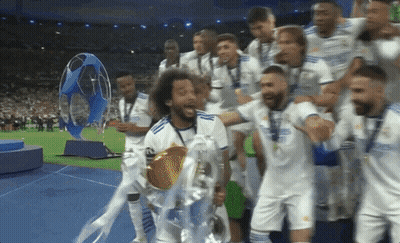 Soccer Players Holding Trophy On Field GIF