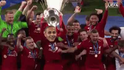 Soccer Players Holding Trophy With Mask GIF
