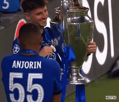 Soccer Players Holding Trophy GIF