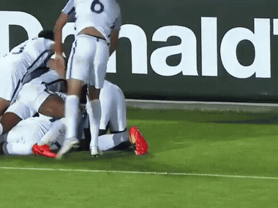 Soccer Players Huddled In Front Of McDonald's Sign GIF