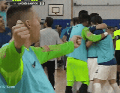 Soccer Players Hugging In Front Of Andreis Santos Scoreboard GIF