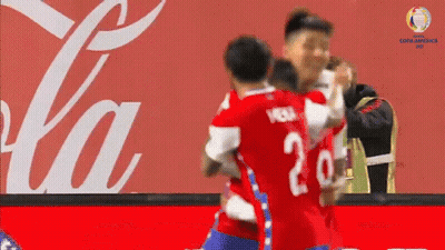 Soccer Players Hugging In Front Of Coca Cola Ad GIF