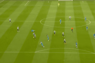 Soccer Players Hugging In Front Of Newcastle Sign GIF