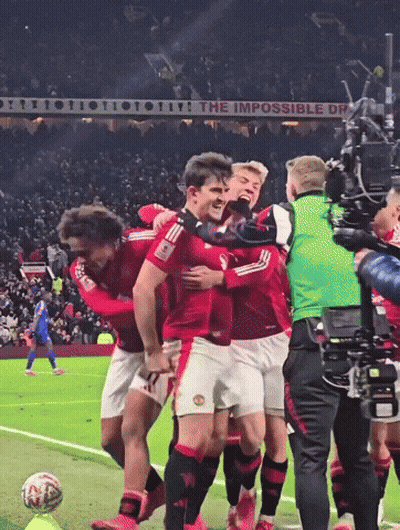 Soccer Players Hugging In Front Of The Impossible Dream Sign GIF
