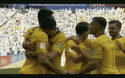 Soccer Players Hugging On Field With Crowd GIF