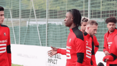 Soccer Players In Front Of Football Impact Fence GIF