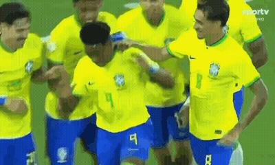 Soccer Players In Yellow And Blue Celebrating Goal GIF