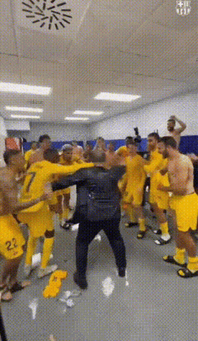 Soccer Players In Yellow Uniforms Dancing In Locker Room GIF