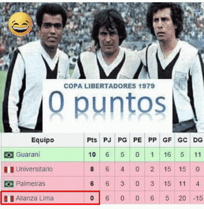 Soccer Players Next to O Puntos Sign
