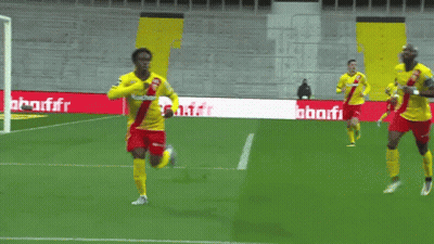 Soccer Players On A Field With A Banner That Says Auchan GIF