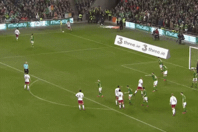 Soccer Players On A Field With A Banner That Says Three.ie On It GIF