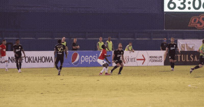 Soccer Players On A Field With A Pepsi Banner GIF