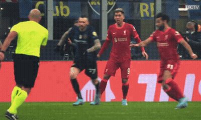 Soccer Players On A Field With A Yellow Referee And A Sign That Says Club GIF