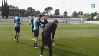 Soccer Players On Field With Blue Uber Sign GIF
