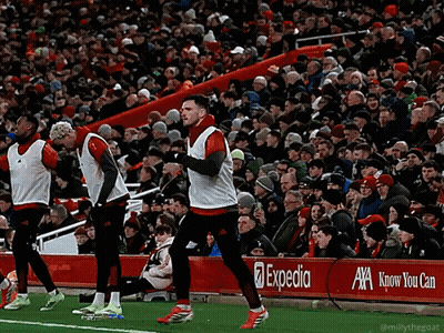 Soccer Players on Field With Expedia Banner