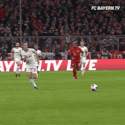 Soccer Players On Field With FC Bayern.tv Background GIF