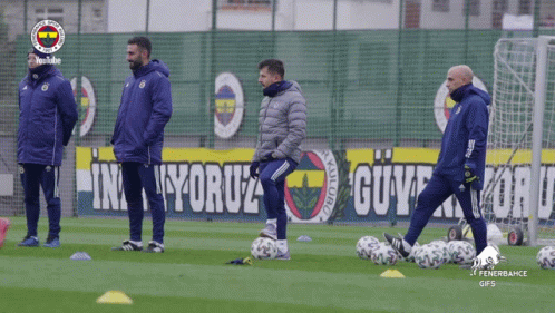 Soccer Players On Field With Fenerbahce Banner GIF