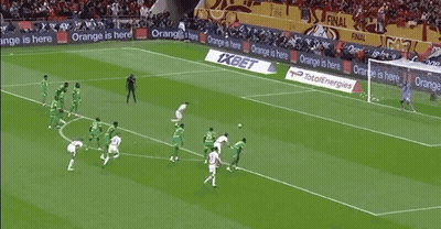 Soccer Players On Field With Orange And XBet Ads GIF