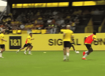 Soccer Players On Field With T & T Sign GIF