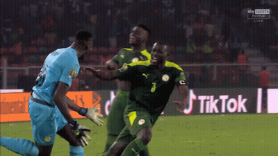 Soccer Players On Field With TikTok Sign GIF