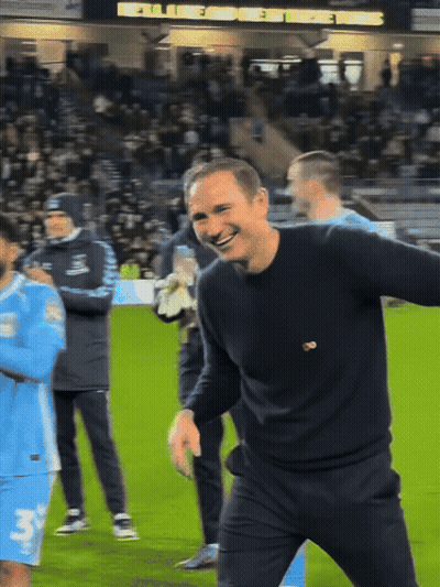 Soccer Players On Field With UCFB GIZ Ads GIF