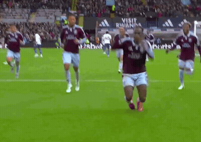 Soccer Players On Field With Visit Rwanda Sign GIF