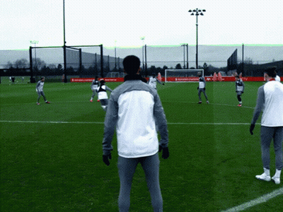 Soccer Players Playing On Field With Coca Cola Banner GIF