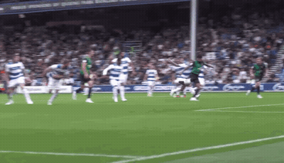 Soccer Players Playing On Field With Sponsors Of Queens Park Sign GIF