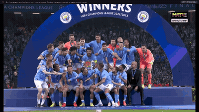 Soccer Players Posing Under Winners Banner GIF