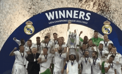 Soccer Players Posing Under Winners Sign GIF