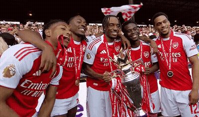 Soccer Players Posing With Emirates Fly Bet Trophy GIF