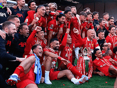 Soccer Players Posing With Trophy And Standard Chartered Shirt GIF